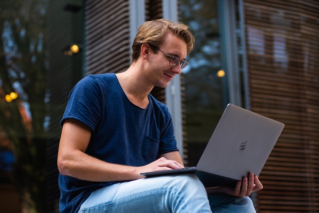 selective focus photo of man using laptop 1438081